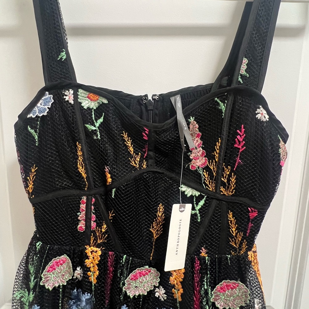Black and multi colored flower appliqué